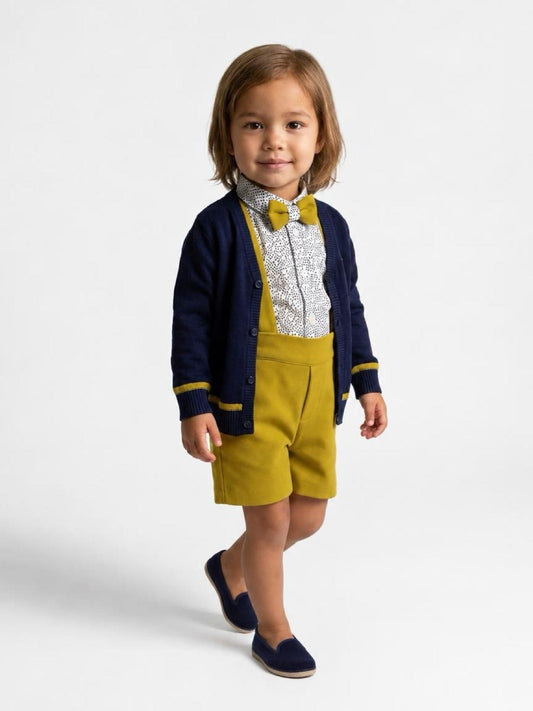 Bambino con completo Never Too cardigan blu, camicia con papillon e bermuda senape